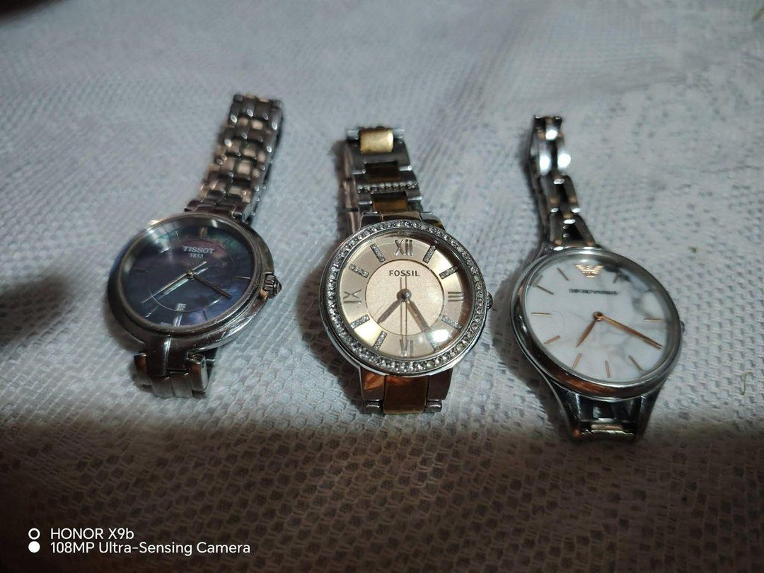 TISSOT, FOSSIL, ARMANI (Category: Women's Watches) located in Cavite. Submitted by gedom (Listing ID 1456092005, Image 1). Description: Tissot 1853 analog watch (left) and Fossil two-tone crystal bezel watch (middle).Emporio Armani Aurora (Model AR11167), featuring a distinctive white marble dial and a polished stainless steel bracelet 20k take all Dasma cavite.