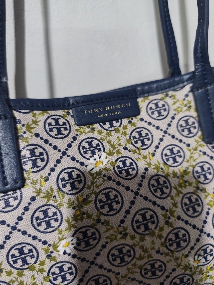 Tory Burch T Monogram Floral Vine Tote (Category: Tote Bags) located in Rizal. Submitted by chicout (Listing ID 1456208992, Image 2). Description: - Authentic Tory Burch tote bag - Features iconic logo pattern with a charming floral print - Stylish navy blue trim and handles - Ideal for everyday use - Spacious interior for all your essentials - Sign of use inly, see last picture for ref..
