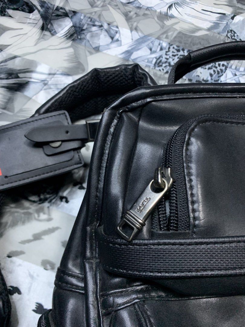 Tumi Black Leather Backpack with laptop compartment (Category: Luxury Bags & Wallets) located in Polomolok. Submitted by domingthriftclothes (Listing ID 1456187117, Image 3). Description: - Genuine Tumi black leather backpack - Multiple zippered compartments for excellent organization - Padded shoulder straps for maximum comfort - Comes with an authentic Tumi luggage tag - Spacious interior, ideal for travel or everyday essentials.