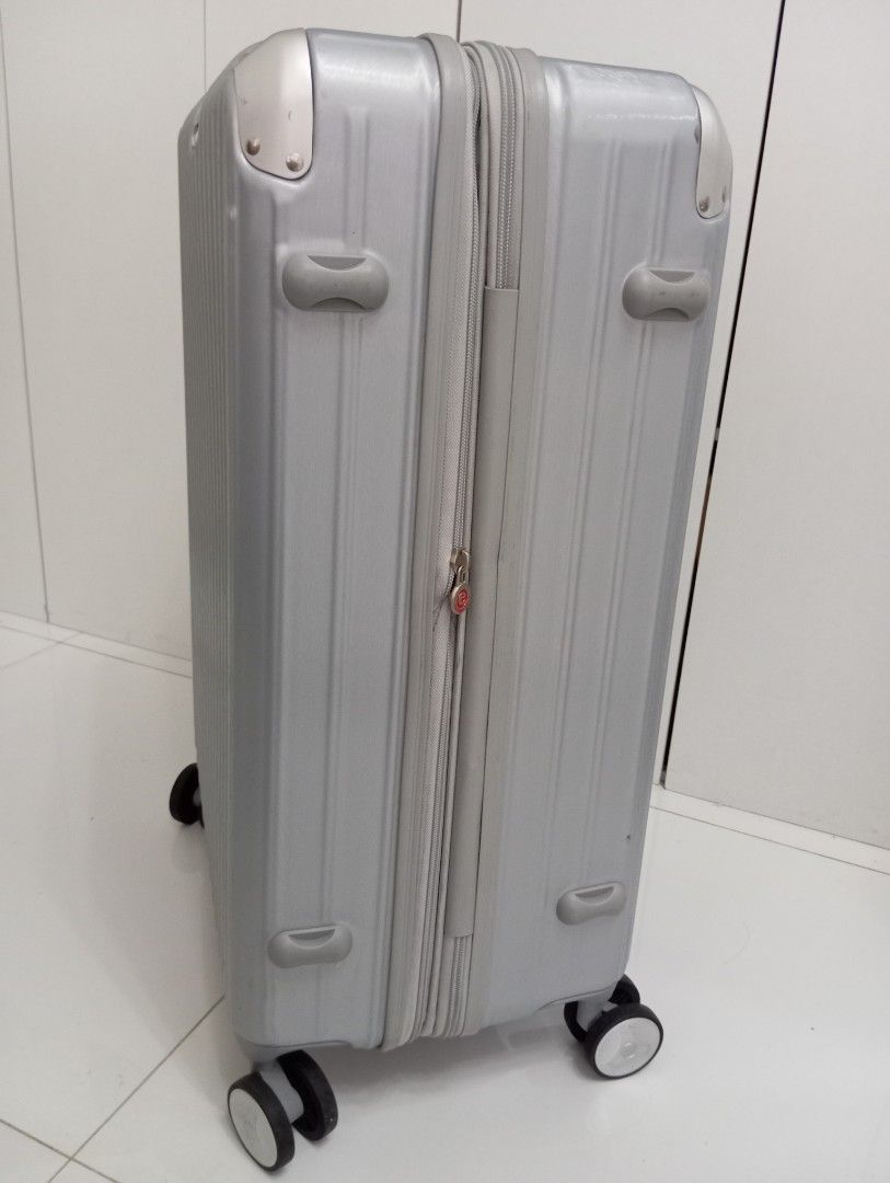 URBAN Silver Spinner Luggage (Category: Luggage) located in Quezon City. Submitted by babybubots (Listing ID 1456068714, Image 2). Description: - Sleek silver luggage from URBAN - Durable ribbed exterior for added protection. - Effortless maneuverability with four spinner wheels - Interior features multiple compartments and securing straps for organized packing. - Built-in TSA lock for secure and convenient travel. - Ideal for all your travel adv