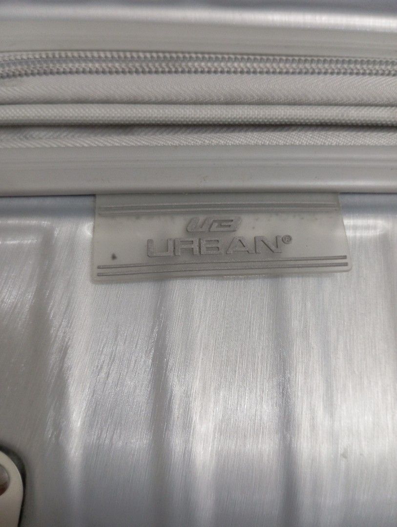 URBAN Silver Spinner Luggage (Category: Luggage) located in Quezon City. Submitted by babybubots (Listing ID 1456068714, Image 3). Description: - Sleek silver luggage from URBAN - Durable ribbed exterior for added protection. - Effortless maneuverability with four spinner wheels - Interior features multiple compartments and securing straps for organized packing. - Built-in TSA lock for secure and convenient travel. - Ideal for all your travel adv