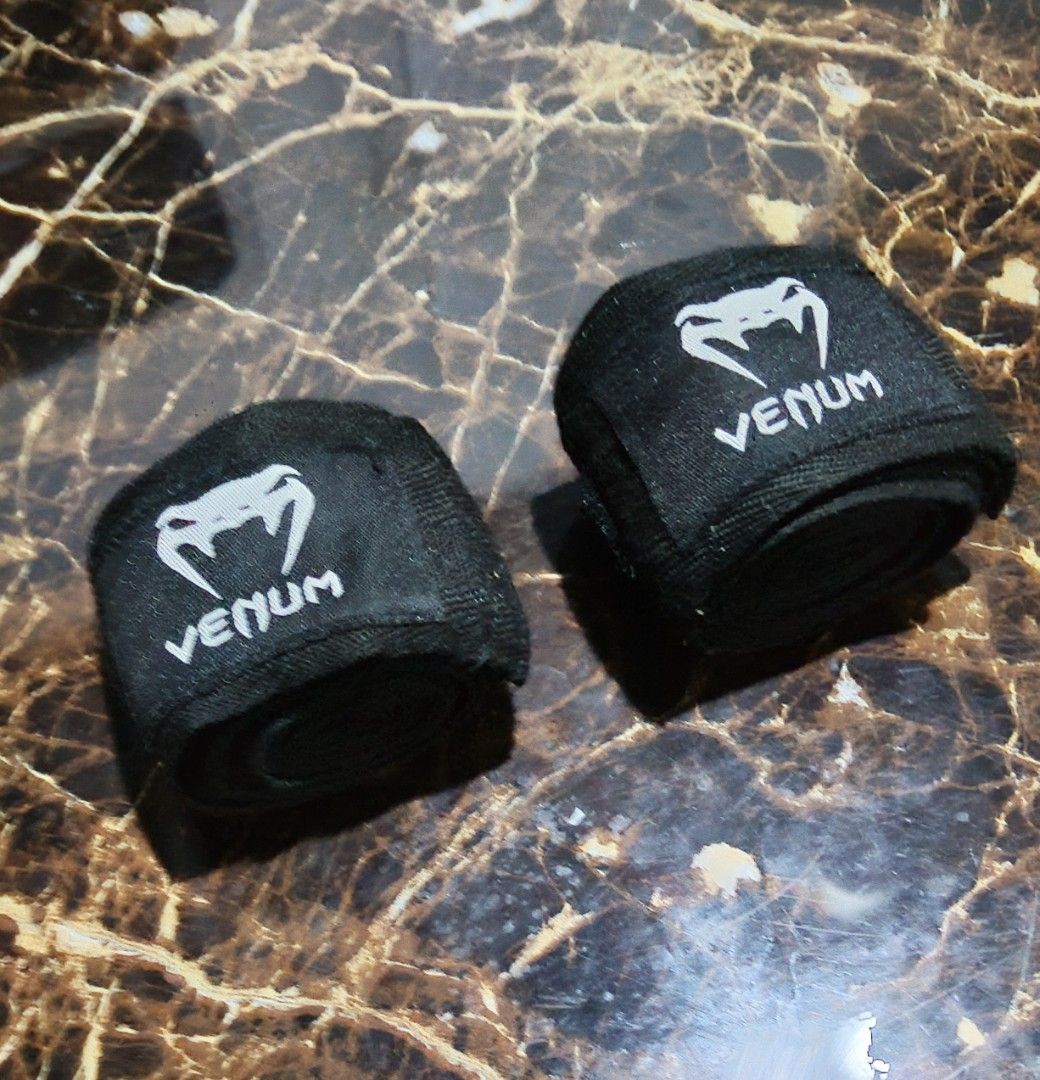 Venum Black Hand Wraps for Boxing/MMA (Category: Combat Sports) located in Taguig. Submitted by wethrifting2021 (Listing ID 1456210866, Image 2). Description: - Brand: Venum - Color: Black - Type: Standard length hand wraps - Benefit: Provides hand protection during training - Condition: Ready for your next workout.