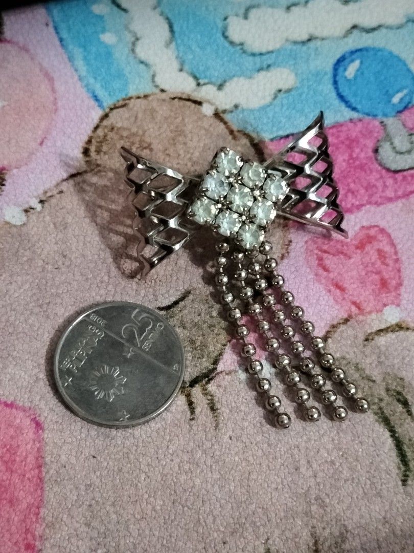 Vintage Bow Rhinestone Brooch with Dangling Beads (Category: Brooches) located in Santa Ana. Submitted by erikarasu (Listing ID 1456169812, Image 2). Description: - Elegant silver-tone bow brooch - Adorned with sparkling clear rhinestones - Features delicate dangling beaded chains - Crafted in Japan - Adds a touch of glamour to any outfit - Secure pin closure on the back No refunds no returns SF to be bandled by the buyer.