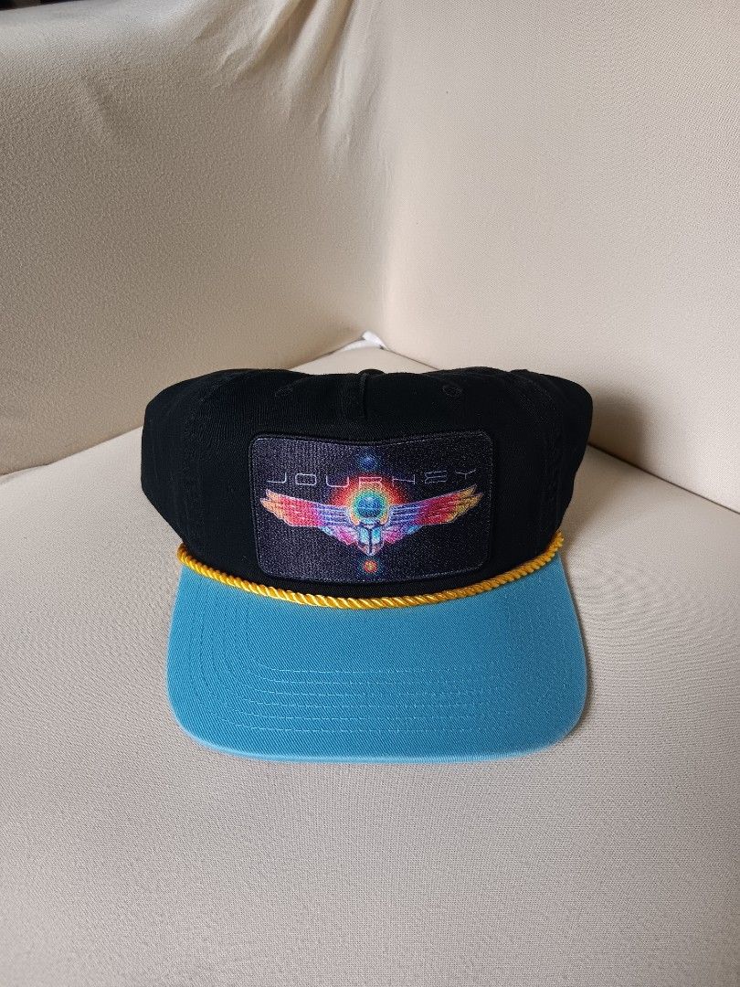 vintage Journey band trucker snapback hat (Category: Caps & Hats) located in Manila. Submitted by gerryanton77059 (Listing ID 1456072763, Image 1). Description: This is a vintage Journey band trucker snapback hat featuring a colorful embroidered scarab beetle and wings patch with a bright blue brim and yellow rope accent..