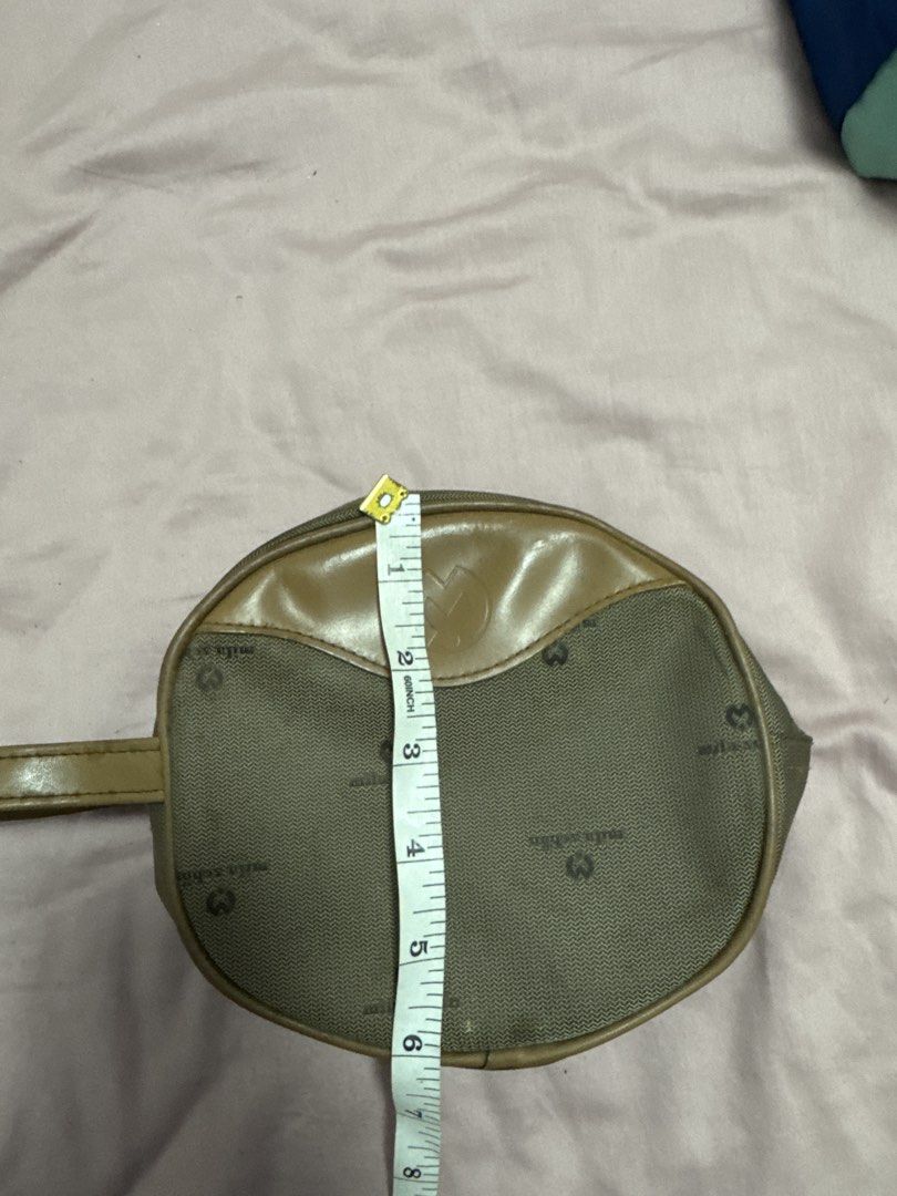 2027 Mila Schön Pouch Bag (Category: Luxury Bags & Wallets) located in Silang. Submitted by sari2bilina (Listing ID 1456330390, Image 1). Description: - Brown Mila Schön pouch - All-over monogram print - Leather handle and trim - Zipper closure - 'MENARD' logo inside - Approx. 6 inches in height.
