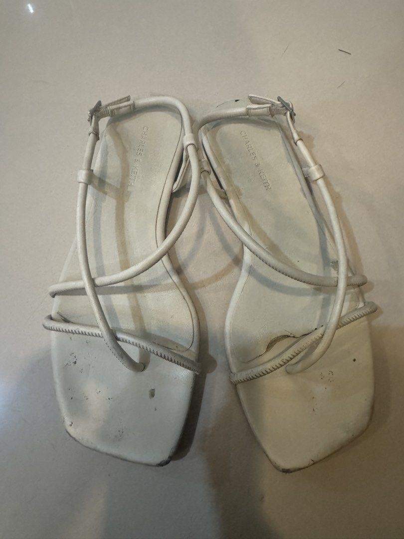 37 Charles & Keith White Strappy Flat Sandals Size 37 (Category: Flats & Sandals) located in Manila. Submitted by decluterthings888 (Listing ID 1456360179, Image 1). Description: - Brand: Charles & Keith - Color: White - Style: Strappy sandals - Toe Shape: Square toe - Features: Adjustable ankle strap - Condition: Soles show some wear - Occasion: Great for casual outings.