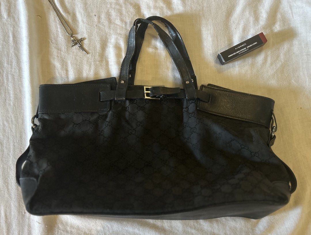 (Authentic) Gucci GG Canvas Belted Tote Bag (Category: Luxury Bags & Wallets) located in San Jose del Monte. Submitted by declutteriri (Listing ID 1456285987, Image 1). Description: Text me for inquiries. I cant see Carousell messages. I used this as a school bag and it fits my laptop. Brand: Gucci Style: Tote / Shoulder Bag Color: Black Material: GG Monogram Canvas with Leather Trim Hardware: Silver-tone Closure: Open top with strap/buckle accen