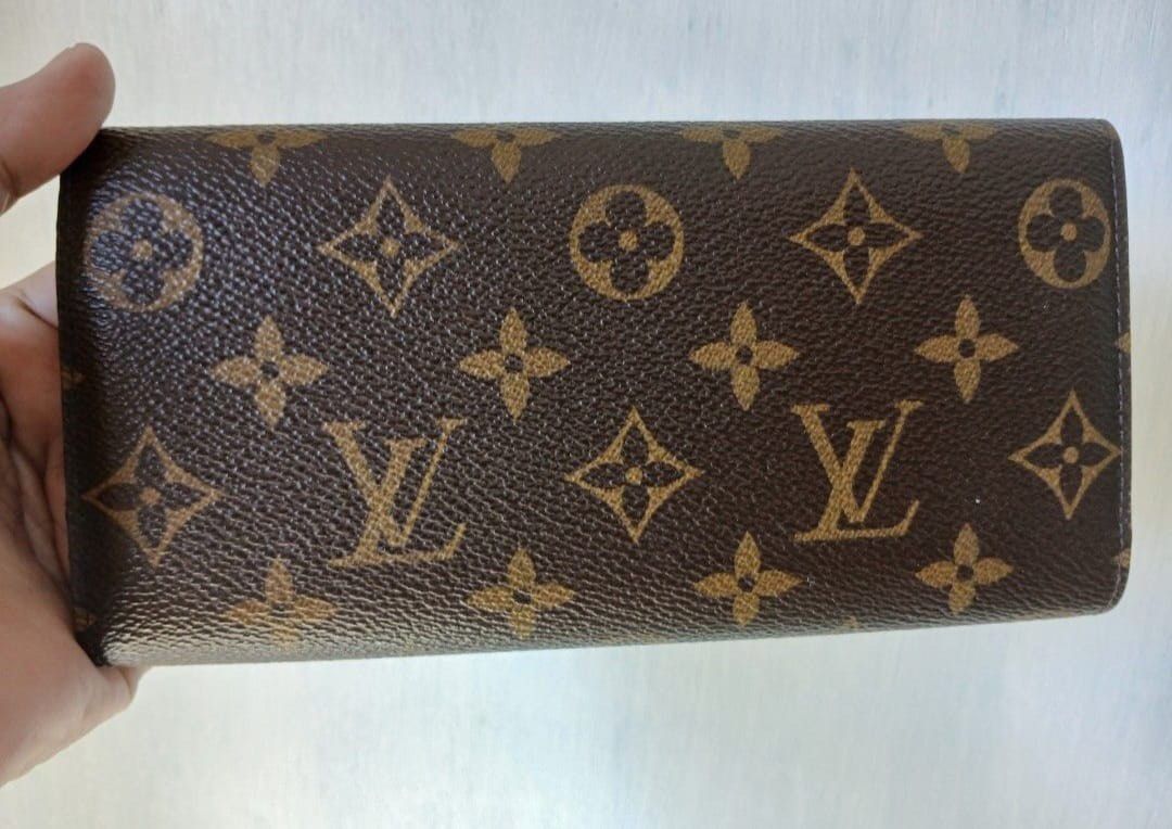Authentic Emillie Louis Vuitton Monogram Canvas Wallet with Red Interior (Category: Luxury Bags & Wallets) located in Taguig. Submitted by sandzclick (Listing ID 1456307685, Image 2). Description: - Classic Louis Vuitton monogram canvas wallet - Vibrant red interior for a pop of color - Ample card slots for organization - Zippered compartment for coins or small essentials - Secure snap closure to keep everything safe - Timeless and practical for 