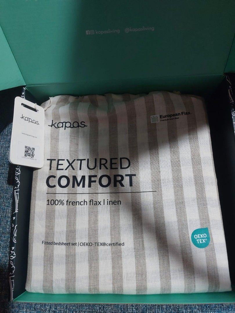 Bedsheets (Category: Bedding & Towels) located in Singapore. Submitted by aaashahproperty (Listing ID 1456269177, Image 3). Description: - Brand: Kapas - Size: Super Single - Material: 100% French Flax Linen - Feature: Textured Comfort - Certification: OEKO-TEX certified - Design: Neutral stripe pattern - Packaging: Comes in original Kapas box - Condition: New (implied by packaging and listing details).