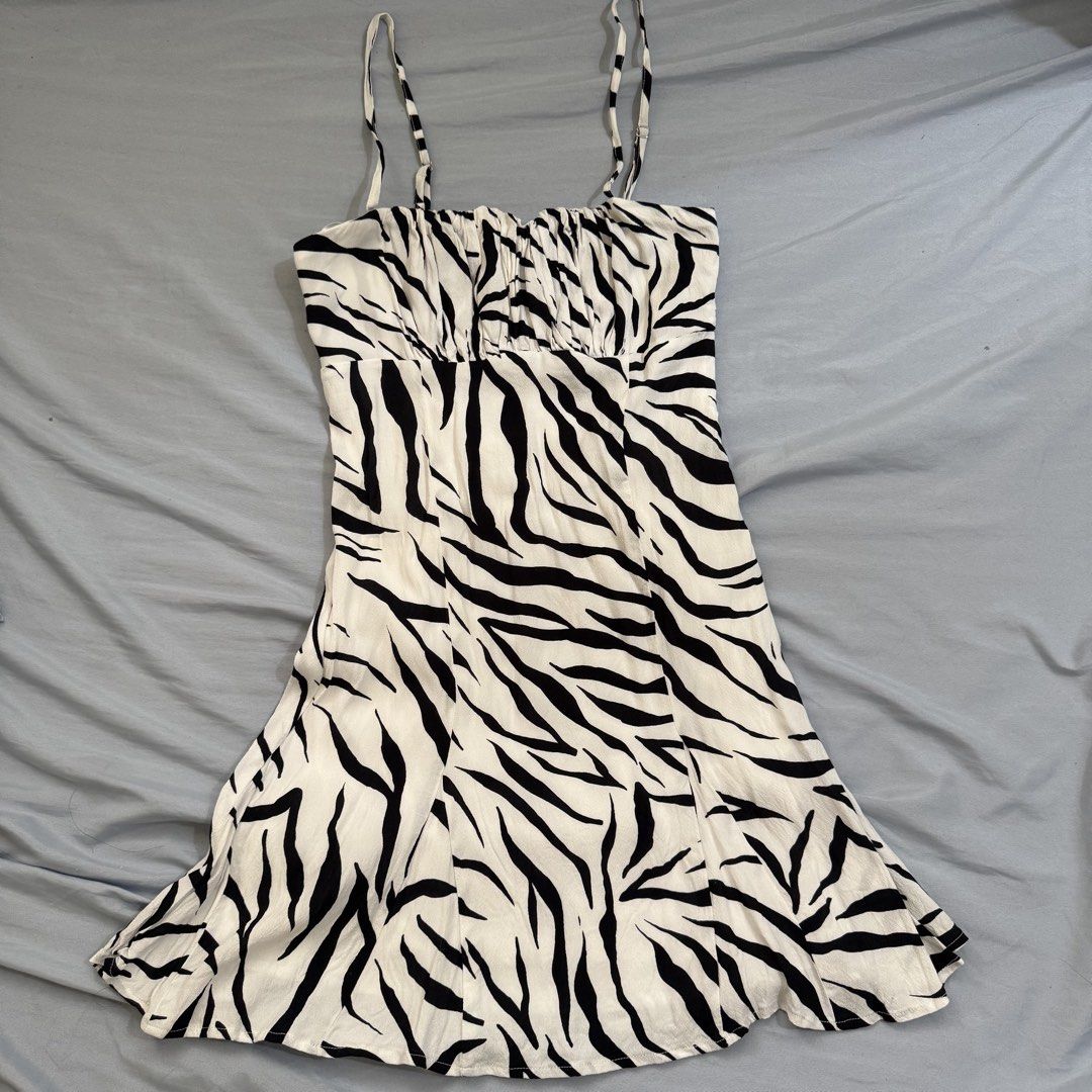 Bershka Ruched Mini Dress (Category: Dresses) located in Cagayan de Oro. Submitted by kheyx (Listing ID 1456267878, Image 1). Description: - zebra print mini dress from Bershka - Size S - Features a ruched bust - Adjustable spaghetti straps - Lightweight and flowy fabric - Perfect for nights out or casual wear - Brand new, never worn above knee length side zipper.