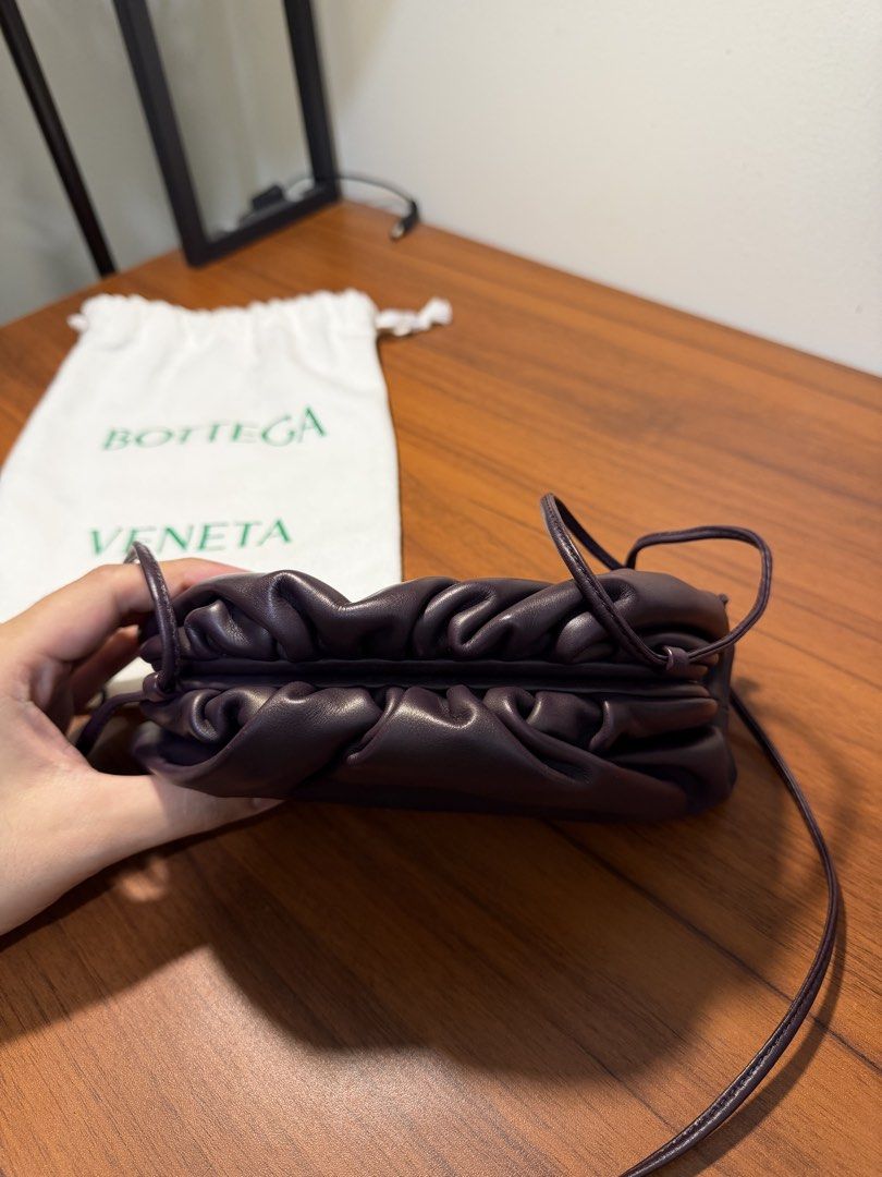 Bottega Veneta The Pouch Mini Plum (Category: Luxury Bags & Wallets) located in Pasig City. Submitted by marcodoge (Listing ID 1456360441, Image 3). Description: 100% Authentic! Retails for 140k+ • Soft and rounded frame clutch in smooth butter leather • Lined in nappa for a clean finish • Logo is discreetly embossed inside • Includes original dustbag Very versatile since sling can shortened. Can be worn crossbody, over the shoulder, or as a clut