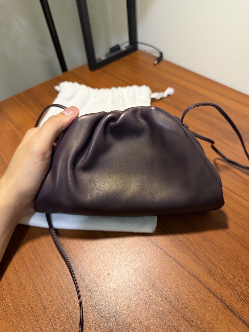 Bottega Veneta The Pouch Mini Plum (Category: Luxury Bags & Wallets) located in Pasig City. Submitted by marcodoge (Listing ID 1456360441, Image 2). Description: 100% Authentic! Retails for 140k+ • Soft and rounded frame clutch in smooth butter leather • Lined in nappa for a clean finish • Logo is discreetly embossed inside • Includes original dustbag Very versatile since sling can shortened. Can be worn crossbody, over the shoulder, or as a clut