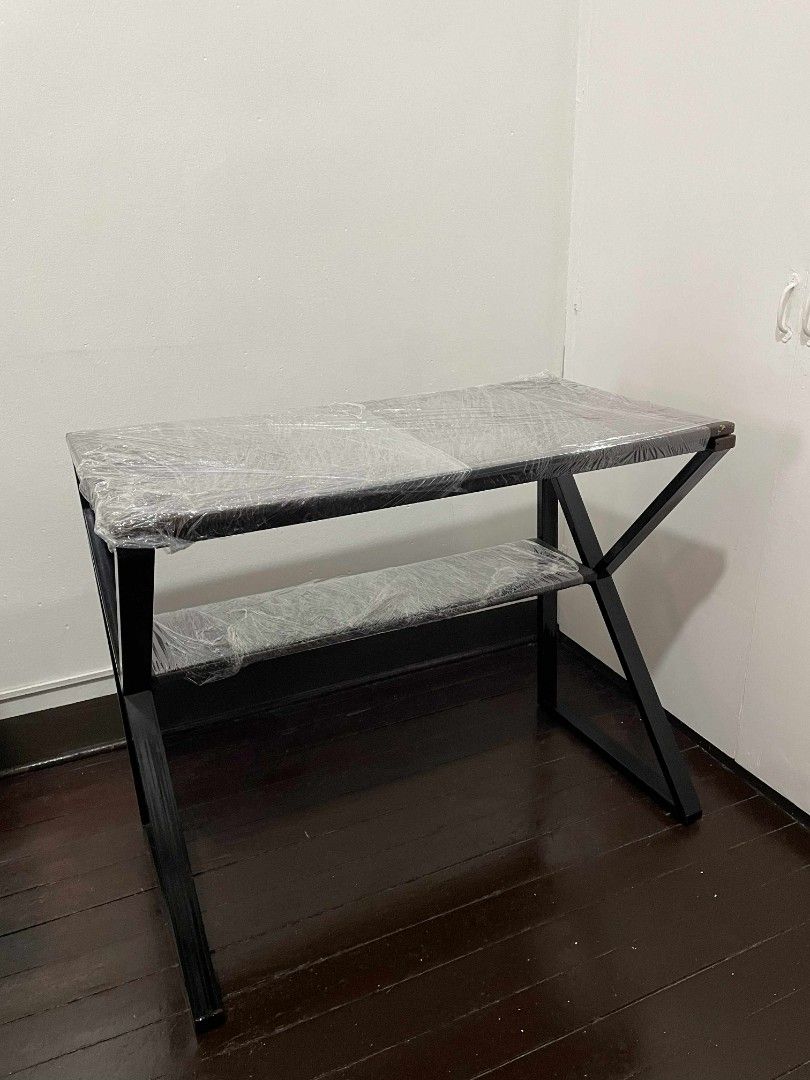 Brown Metal Desk with Shelf (Category: Tables & Sets) located in Manila. Submitted by schullerfa14049 (Listing ID 1456286046, Image 1). Description: - Simple brown, pure metal desk with convenient shelf - Brown soft tabletop - Modern, angled leg design for a stylish look - Protective plastic wrap on desk surface (removable) - Approximate dimensions: 35 inches wide, 29 inches tall - Ideal for study, home office, or workspace - Noticeable issues (s