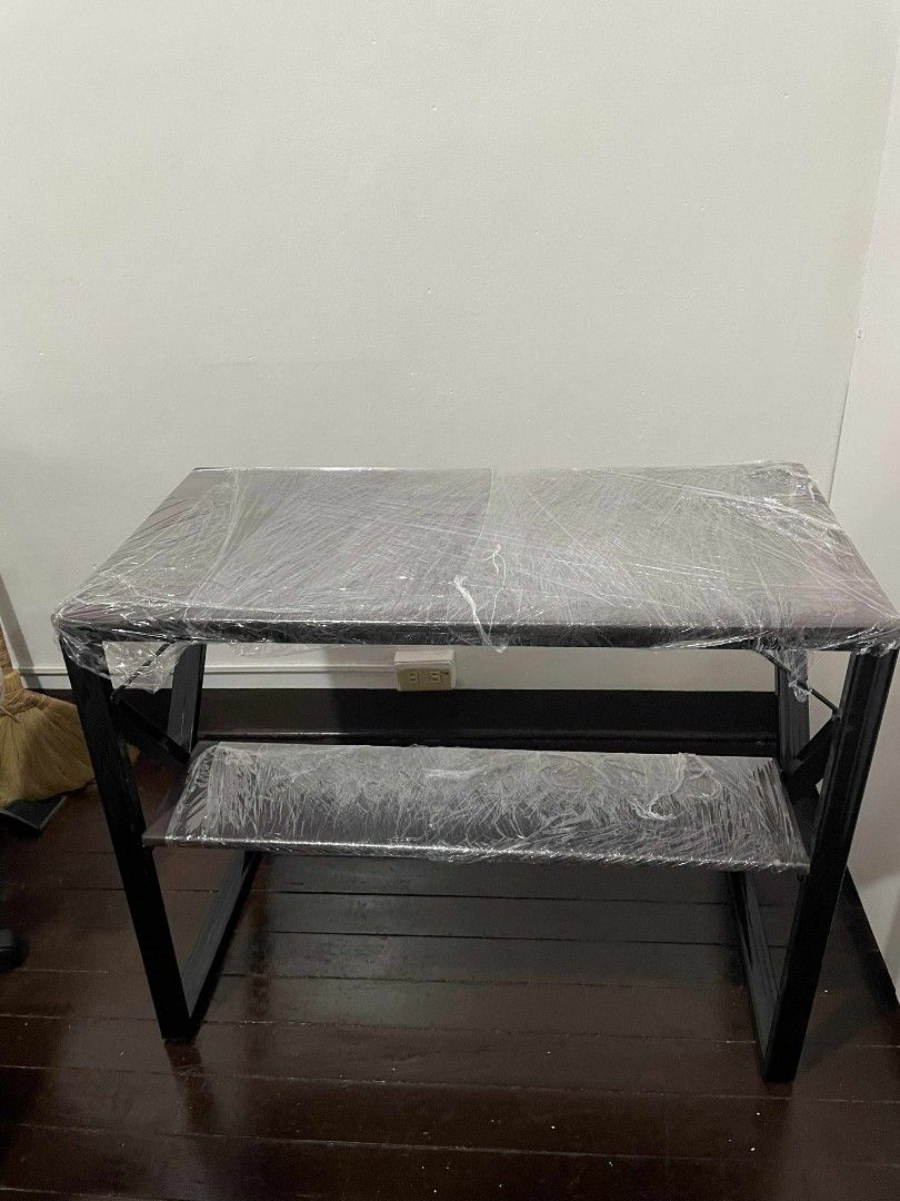Brown Metal Desk with Shelf (Category: Tables & Sets) located in Manila. Submitted by schullerfa14049 (Listing ID 1456286046, Image 2). Description: - Simple brown, pure metal desk with convenient shelf - Brown soft tabletop - Modern, angled leg design for a stylish look - Protective plastic wrap on desk surface (removable) - Approximate dimensions: 35 inches wide, 29 inches tall - Ideal for study, home office, or workspace - Noticeable issues (s