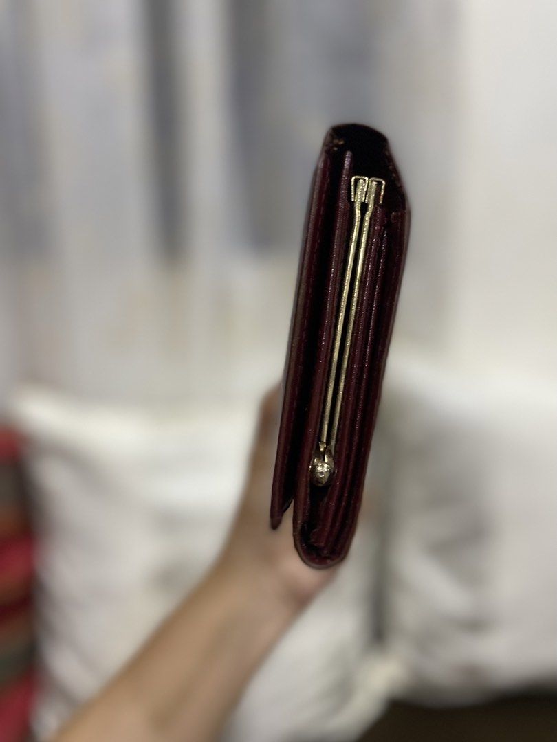 Cartier Burgundy Leather Long Wallet (Category: Wallets & Card holders) located in Cadiz. Submitted by saveandstyleph (Listing ID 1456345416, Image 3). Description: - Burgundy leather long wallet from Cartier - Iconic Cartier logo embossed on the front - Secure clasp closure - Multiple interior card slots - Minor scuffs on exterior leather - A classic and essential accessory.
