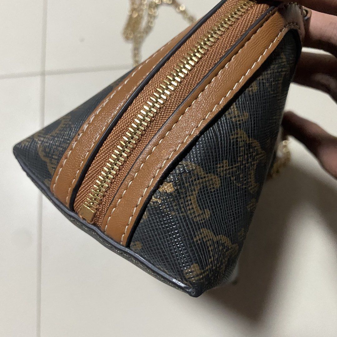 Celine Triomphe Canvas Shoulder Bag (Category: Luxury Bags & Wallets) located in Zamboanga. Submitted by thriftyyali (Listing ID 1456410169, Image 3). Description: - Authentic Celine pouch bag in iconic Triomphe canvas. - Chic brown and tan colorway. - Features a stylish gold chain strap. - Secure zipper closure. - Ideal size for carrying your essentials (approx. 7" L x 4" H)..