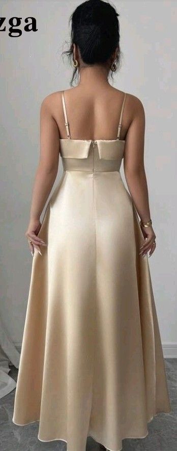 Champagne Satin Spaghetti Strap Long Dress (Category: Dresses) located in San Pedro. Submitted by JohnsonKeeps (Listing ID 1456307286, Image 2). Description: - Elegant Champagne Satin long dress - Spaghetti straps - Zipper closure at the back - Fabric has a beautiful sheen - Ideal for events and parties - Size: Large (L).