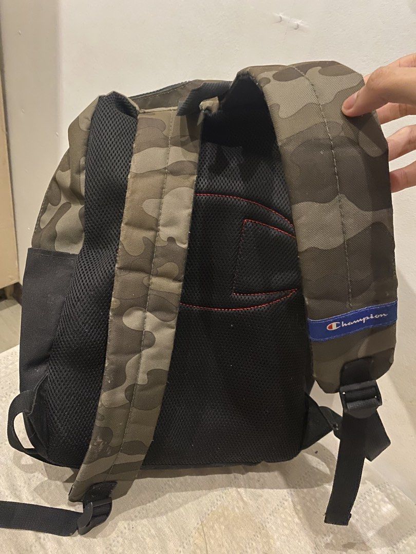 Champion Manuscript Backpack (Category: Backpacks) located in Malolos. Submitted by freestorm_35f01a (Listing ID 1456362316, Image 2). Description: - Cool camo print Champion backpack - Black bottom with white Champion logo - Padded straps for comfort - Main compartment and front zip pocket - Ideal for school or everyday use - Shows some signs of wear, but plenty of life left.