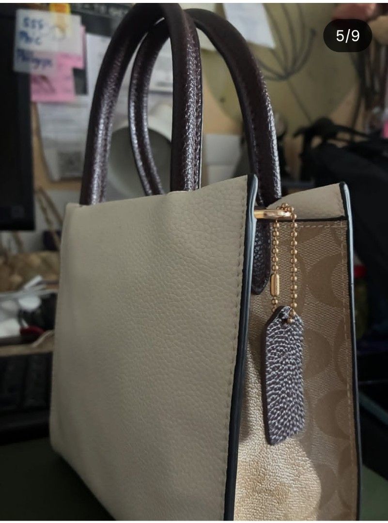 Coach Mini Cally Pebble Leather Hand Bag (Category: Luxury Bags & Wallets) located in Quezon City. Submitted by never_a_clutter (Listing ID 1456297528, Image 3). Description: - Brand: Coach - Material: White pebble leather - Handle color: Dark brown - Hardware: Gold Coach New York logo on front - Style: Classic everyday tote - Features: Plenty of interior space - FLAW: NO SLING - AUTHENTICITY NOT GUARANTEE.