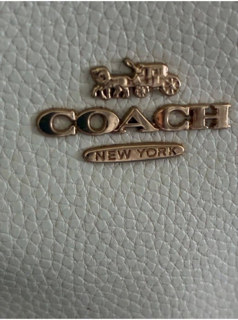 Coach Mini Cally Pebble Leather Hand Bag (Category: Luxury Bags & Wallets) located in Quezon City. Submitted by never_a_clutter (Listing ID 1456297528, Image 2). Description: - Brand: Coach - Material: White pebble leather - Handle color: Dark brown - Hardware: Gold Coach New York logo on front - Style: Classic everyday tote - Features: Plenty of interior space - FLAW: NO SLING - AUTHENTICITY NOT GUARANTEE.