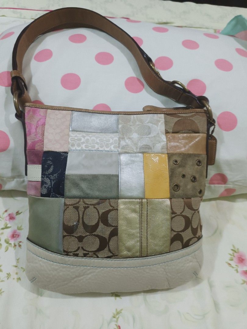 Coach Patchwork Shoulder Bag (Category: Luxury Bags & Wallets) located in Capas. Submitted by rayapretty55453 (Listing ID 1454566604, Image 2). Description: - Unique Coach shoulder bag - Features classic monogram mixed with patchwork design - Accents in pink, silver, yellow, and brown - Genuine leather straps and trim - Fun and stylish for everyday use.