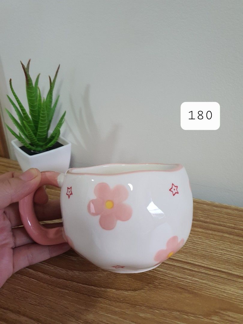 Cute Pink Floral Ceramic Mug (Category: Coffee & Tea Tableware) located in Quezon City. Submitted by cheche14 (Listing ID 1456330456, Image 1). Description: - Adorable mug featuring pink flowers and stars. - Comes with a charming pastel pink handle. - Perfect for your morning coffee or tea. - Nice, balanced size – not too big, not too small. - Makes a wonderful gift idea. - Adds a touch of fun to your drinkware..