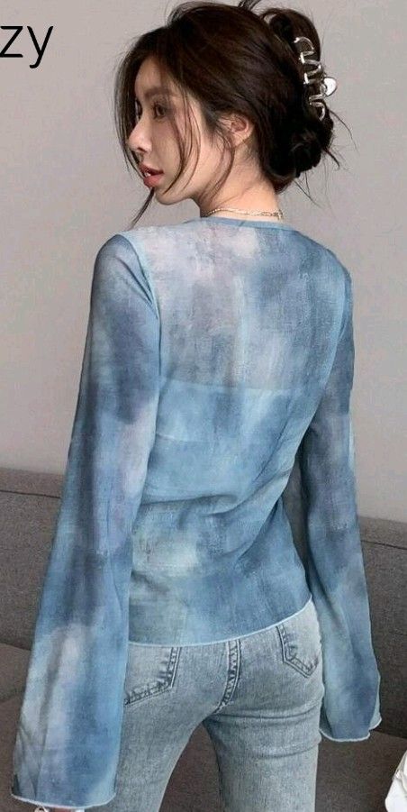 Dazy Blue Tie-Front Bell Sleeve Sheer Top (Category: Blouses) located in San Pedro. Submitted by JohnsonKeeps (Listing ID 1456312240, Image 2). Description: - Sheer blue fabric / long sleeves - Light material - Size: Large - Tie-front design - Bell sleeves - Unique tie-dye pattern - Versatile for layering or wearing on its own - Suitable for night outs or casual days - Comfortable and stylish.