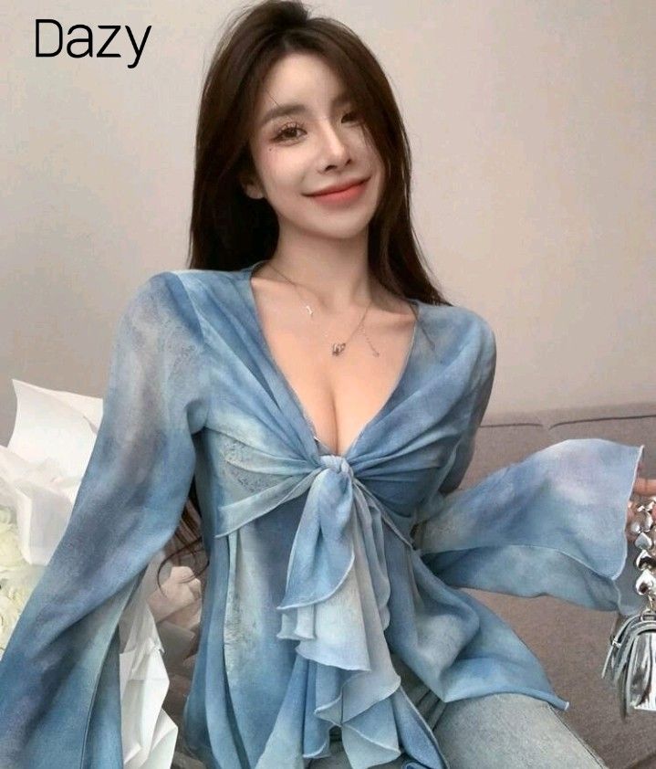 Dazy Blue Tie-Front Bell Sleeve Sheer Top (Category: Blouses) located in San Pedro. Submitted by JohnsonKeeps (Listing ID 1456312240, Image 1). Description: - Sheer blue fabric / long sleeves - Light material - Size: Large - Tie-front design - Bell sleeves - Unique tie-dye pattern - Versatile for layering or wearing on its own - Suitable for night outs or casual days - Comfortable and stylish.