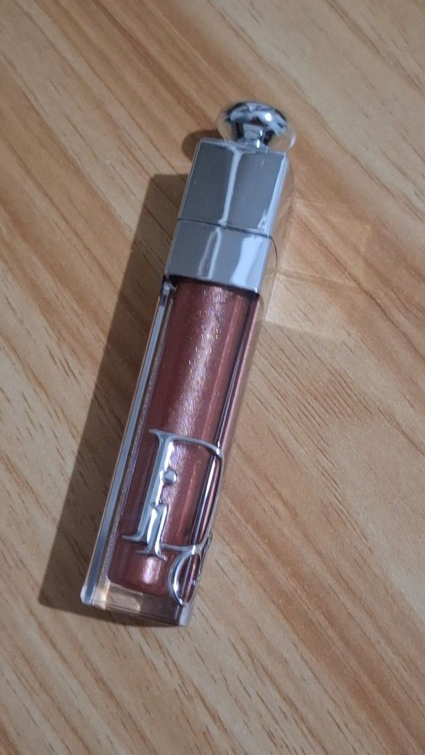 Dior Addict Lip Maximizer Gloss 025 (Category: Makeup) located in Makati City. Submitted by isell_goods (Listing ID 1456345930, Image 1). Description: - Dior Addict Lip Maximizer Gloss - Shade: 025 (Shimmery Rosy-Brown) - Key Benefit: Plumping effect for fuller-looking lips - Finish: Adds shine and a hint of color - Packaging: Sleek silver bottle - Condition: Comes in original bottle.
