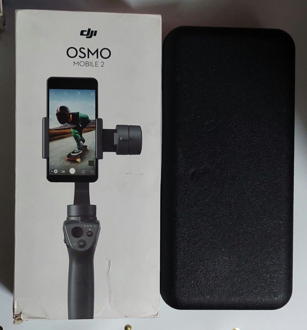 DJI Osmo Mobile 2 Gimbal Stabilizer with Case (Category: Gimbals & Stabilizers ) located in Taguig. Submitted by thrifthub.ph (Listing ID 1456304549, Image 1). Description: DJI Osmo Mobile 2 smartphone gimbal. Includes original box, protective case, and charging cable. Perfect for smooth videos. For Pick up Only. Loc.Taguig.