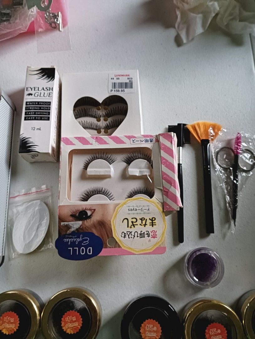 Eyelash Extension Kit with Glue, Lashes, Tools & Case (Category: Makeup) located in Manila. Submitted by iamwhilmz (Listing ID 1456270014, Image 1). Description: - Full eyelash extension kit - Includes lash clusters in various sizes (8mm, 12mm) - Comes with eyelash glue, applicator tools, scissors, and a brush - All organized in a silver carrying case - Some items still in original packaging - Ideal for personal use or professional makeup artists