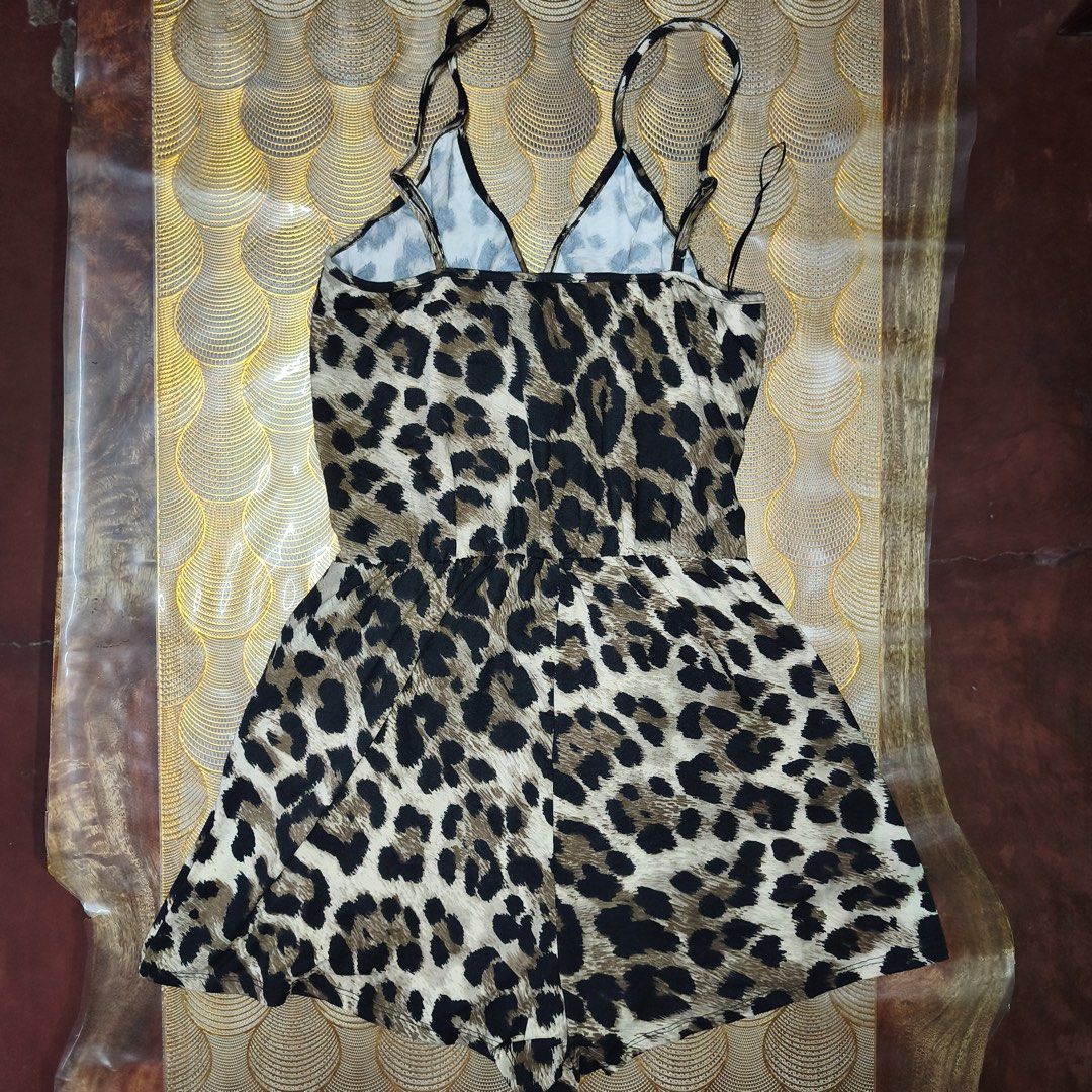 Fashion Nova Leopard Print Spaghetti Strap Romper (Category: Rompers) located in Manila. Submitted by swertecat (Listing ID 1456256033, Image 3). Description: - Fashion Nova leopard print romper - Flattering wrap front design - Delicate spaghetti straps - Lightweight and flowy fabric - Versatile for night out or casual wear - Pairs well with heels or sandals - Medium on tag Antipolo, Rizal.