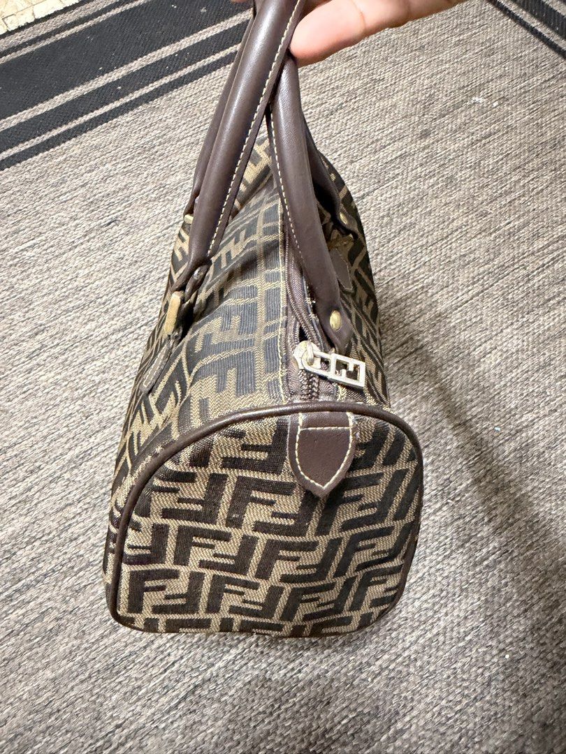 Fendi Zucca Canvas Boston Bag (Category: Luxury Bags & Wallets) located in Las Pinas. Submitted by robisean (Listing ID 1456336191, Image 2). Description: - Classic Fendi Boston bag - Iconic Zucca monogram canvas - Brown and tan colorway - Leather handles and trim - Zipper closure - Perfect for everyday essentials - Shows some signs of wear, but still has plenty of life left Issue Lining Degradation / Peeling Zipper and Plating Wear and Fading.