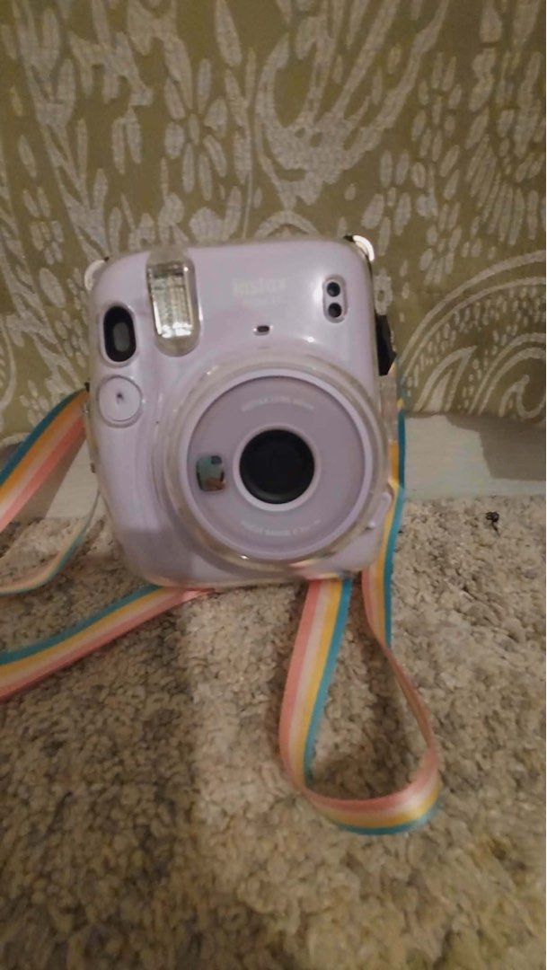 Fujifilm Instax Mini 12 Lavender Instant Camera with Rainbow Strap (Category: Cameras) located in Manila. Submitted by jessicav05 (Listing ID 1456312412, Image 1). Description: - Fujifilm Instax Mini 12 camera in cute lavender color - Super easy to use for instant photos - Includes a fun rainbow strap - Great for capturing party moments and everyday memories.
