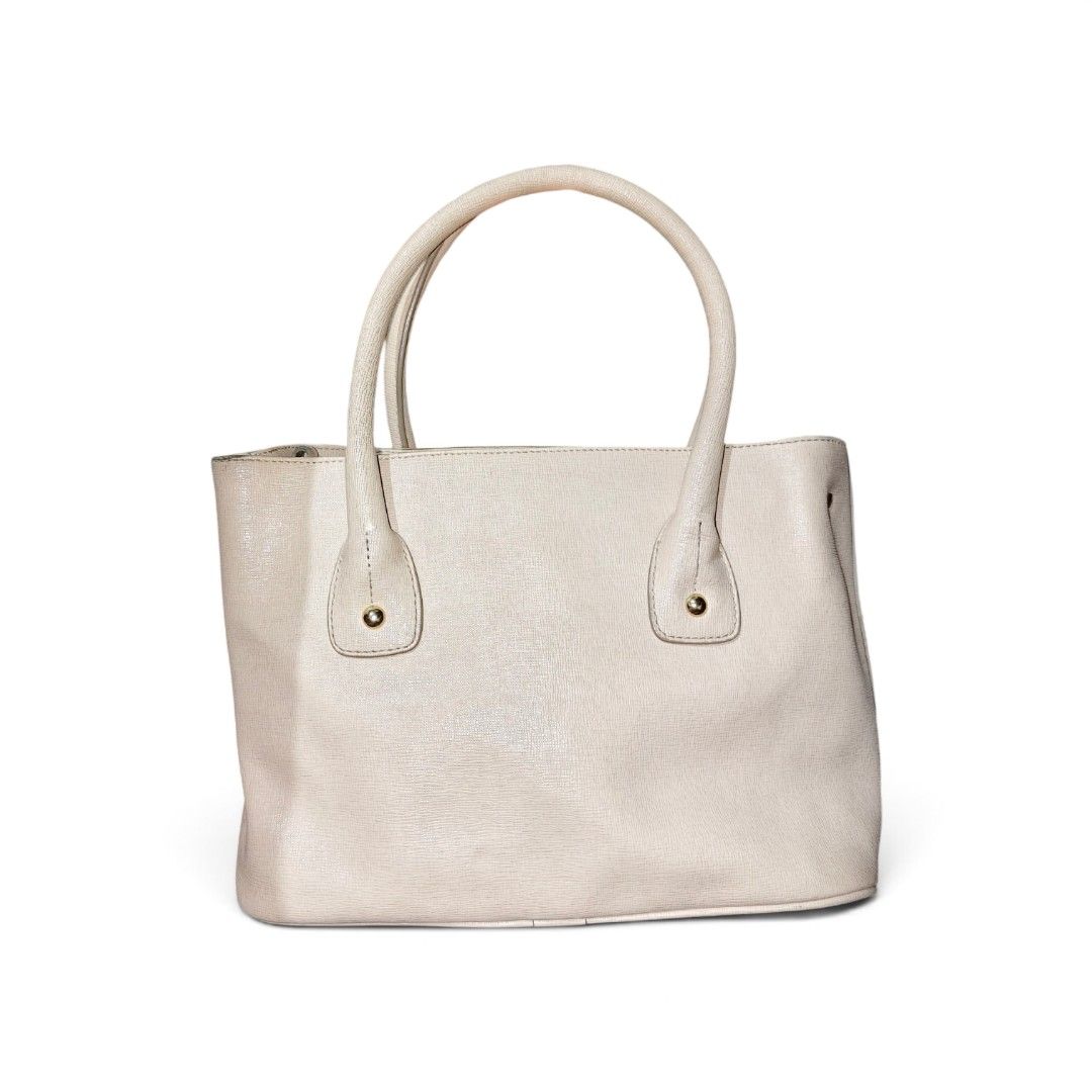 Furla Tote Bag with Shoulder Strap (Category: Luxury Bags & Wallets) located in Munoz. Submitted by harm0nica337 (Listing ID 1456392960, Image 2). Description: -Thrifted Light beige Furla tote bag - Textured leather exterior - Multiple interior pockets flaws: some wear /rubs at the lining bottom of bag as shown in the last pic, needs wash inner lining, with some stains Mop: Gcash (price+sf) j&t.