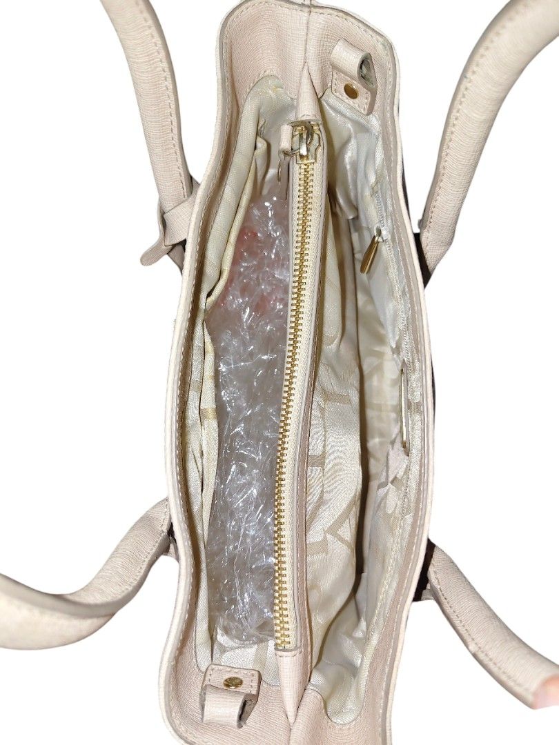 Furla Tote Bag with Shoulder Strap (Category: Luxury Bags & Wallets) located in Munoz. Submitted by harm0nica337 (Listing ID 1456392960, Image 3). Description: -Thrifted Light beige Furla tote bag - Textured leather exterior - Multiple interior pockets flaws: some wear /rubs at the lining bottom of bag as shown in the last pic, needs wash inner lining, with some stains Mop: Gcash (price+sf) j&t.