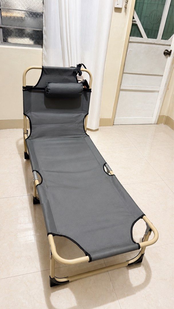 Grey Folding Bed Chair with Pillow (Category: Chairs) located in Manila. Submitted by kweenlee (Listing ID 1456299897, Image 1). Description: - Grey folding lounge chair - Includes a comfortable head pillow - Lightweight and portable for easy transport - Simple to set up and fold away - Ideal for camping, beach trips, or backyard lounging - Features a sturdy frame - Made with durable fabric.