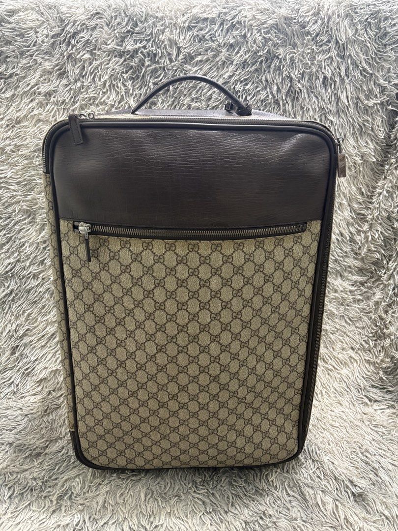Gucci GG Monogram Suitcase (Category: Luxury Bags & Wallets) located in Tarlac. Submitted by yourewelcome.1 (Listing ID 1456355497, Image 1). Description: 16 width 21 length Check last photo for issue - Classic Gucci suitcase - Iconic GG monogram canvas with leather trim - Branded zippers and hardware - Made in Italy - Serial number: 122804 002122 - Ideal for travel.