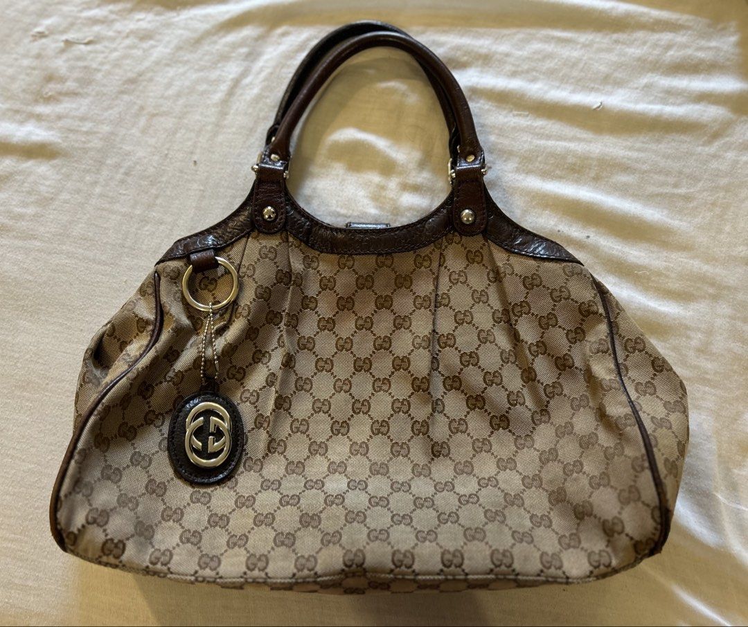Authentic Gucci Sukey Tote Bag (Category: Luxury Bags & Wallets) located in San Jose del Monte. Submitted by declutteriri (Listing ID 1456294417, Image 1). Description: Text me for inquiries. I cant see Carousell messages. Brand: Gucci (Authentic) Style: Shoulder Bag / Tote / Hobo Material: GG Monogram Canvas with Brown Leather Trim and Handles Hardware: Gold-tone Features: Iconic interlocking GG canvas pattern Dual leather shoulder handles Disti