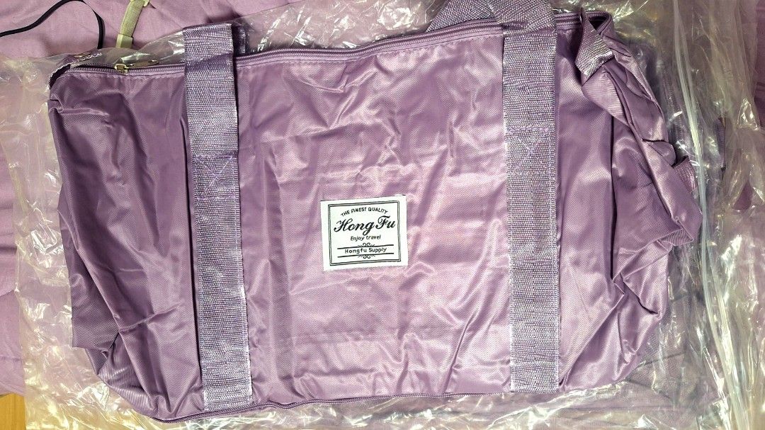 Hong Fu Lavender Nylon Duffel Bag (Category: Beach Bags) located in Quezon City. Submitted by tinylittlecorner (Listing ID 1456241761, Image 3). Description: Lightweight lavender duffel bag by Hong Fu. Perfect for travel or gym. Features main zip, front zip, and interior zip/open pockets. Textured nylon straps. Folds compactly. Perfect for that girls trip! 300 each, 3pcs available Take all 3 for 750!.