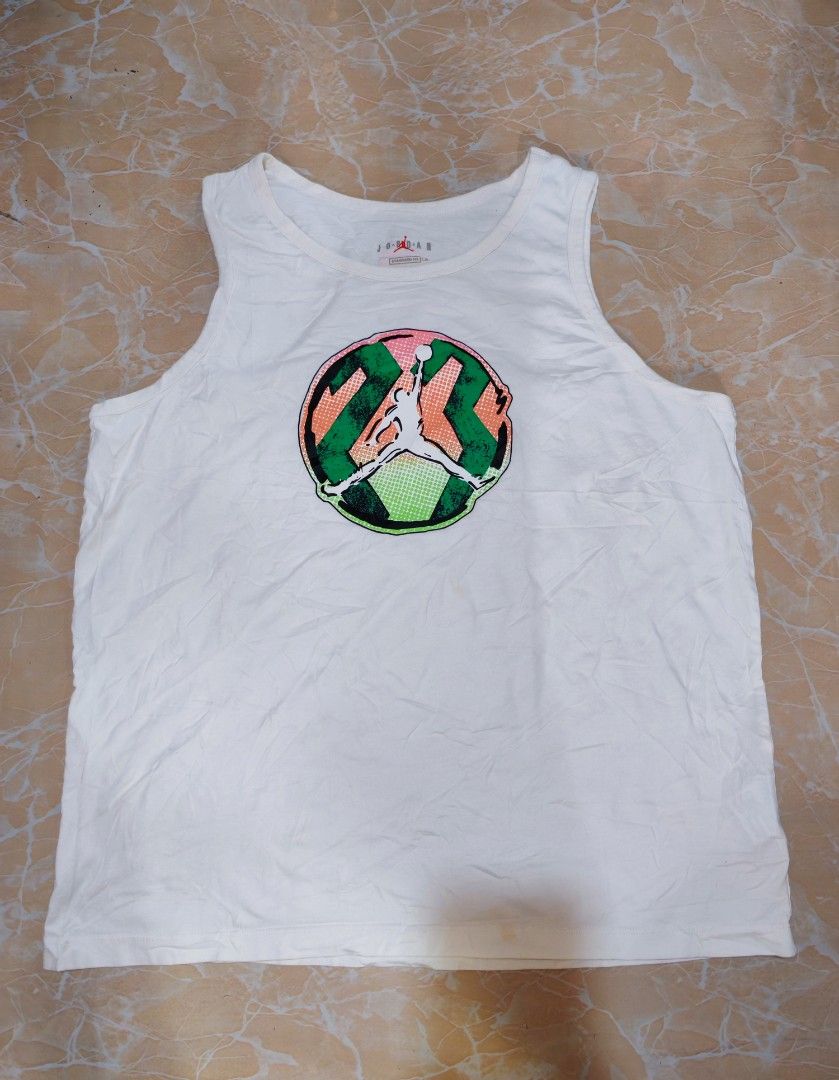 Jordan White Tank Top 3XL (Category: Sleeveless) located in Cotabato. Submitted by rayhan.thriftee (Listing ID 1456289343, Image 1). Description: - White Jordan tank top - Features iconic Jumpman logo with a colorful graphic - Size: 3XL - Material: 100% Cotton - Fit: Standard - Origin: Made in China - Ideal for: Casual wear, workouts, or everyday comfort.