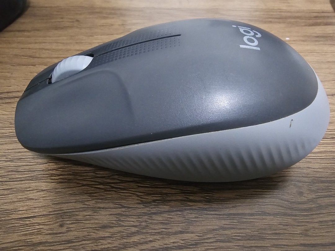 Logitech Wireless Mouse (Category: Mouse & Mousepads) located in Singapore. Submitted by randomsel (Listing ID 1456340299, Image 2). Description: - Logitech wireless mouse - Color: Dark grey with light grey base and scroll wheel - Condition: Works ok, some times might be glitchy - Ideal for: Everyday use.
