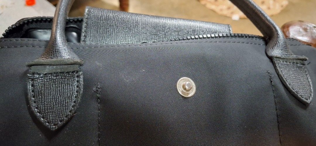 Longchamp Le Pliage doctors Bag Black Nylon Leather (Category: Luxury Bags & Wallets) located in Manila. Submitted by wookiebaby_7 (Listing ID 1456384913, Image 1). Description: Classic doctors bag, durable nylon with leather trim. Snap button and zip closure. Spacious interior. Perfect for daily use or travel. sign of usage as seen in photos..