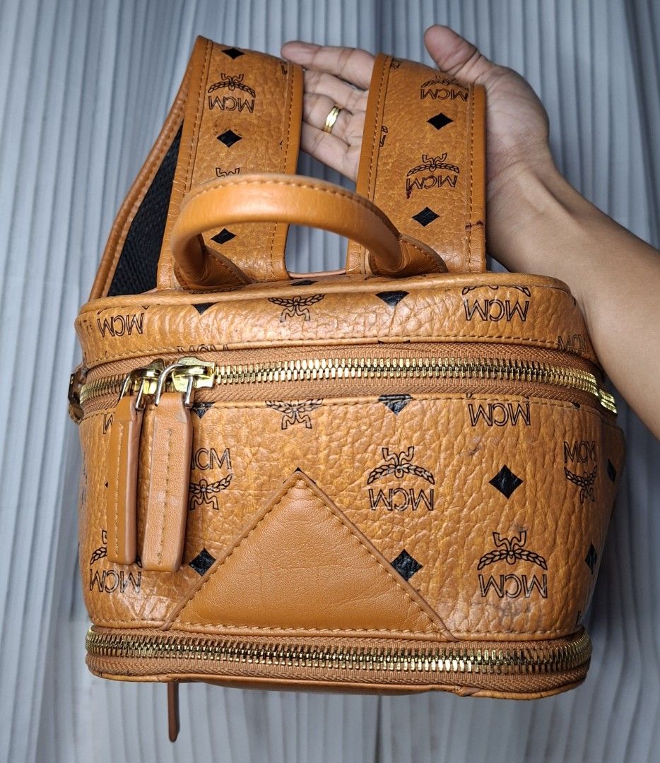 MCM Visetos Backpack Cognac (Category: Luxury Bags & Wallets) located in Nabua. Submitted by alasaasche36553 (Listing ID 1456371275, Image 2). Description: -Y K K zipped - Iconic MCM Visetos print backpack - Classic brown leather trim - Elegant gold hardware - Comfortable adjustable straps - Convenient top handle - Two secure zip compartments - Ideal for daily use and travel.