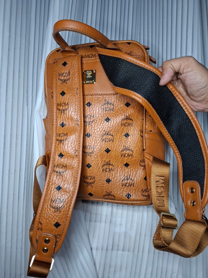 MCM Visetos Backpack Cognac (Category: Luxury Bags & Wallets) located in Nabua. Submitted by alasaasche36553 (Listing ID 1456371275, Image 3). Description: -Y K K zipped - Iconic MCM Visetos print backpack - Classic brown leather trim - Elegant gold hardware - Comfortable adjustable straps - Convenient top handle - Two secure zip compartments - Ideal for daily use and travel.