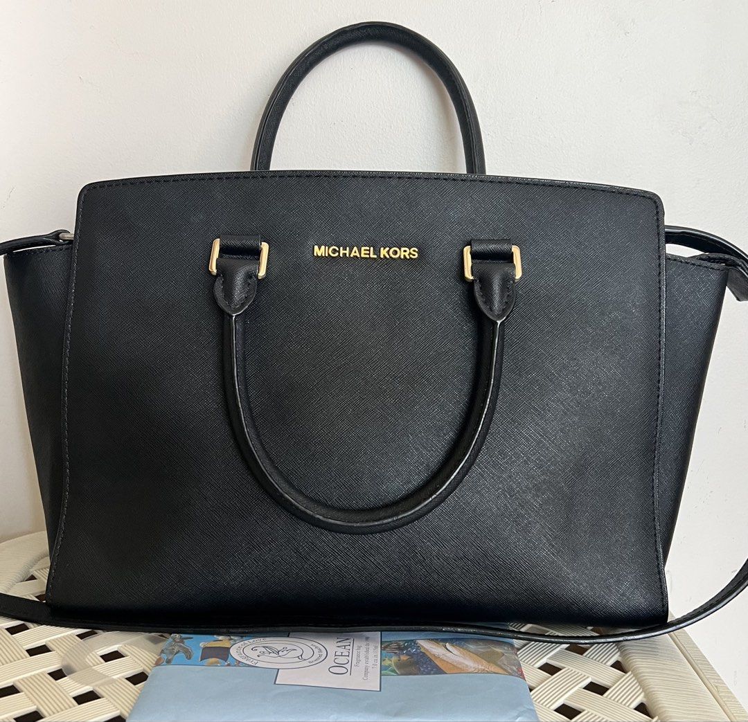 Michael Kors Black Leather Selma (Category: Luxury Bags & Wallets) located in San Juan, Ilocos Sur. Submitted by mklover10 (Listing ID 1456374416, Image 1). Description: - Classic black Michael Kors satchel - Textured leather with gold hardware - Top handles and detachable shoulder strap - Spacious interior for essentials - Versatile for work or casual outings - Clean interior.