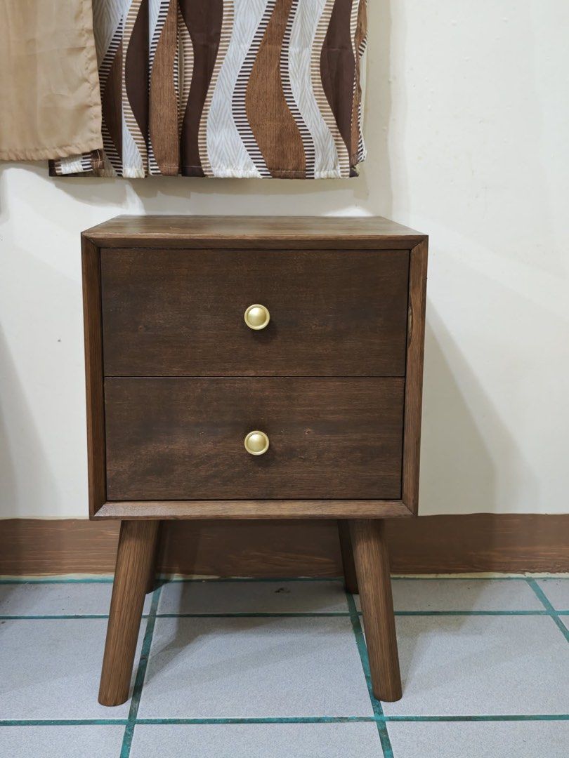Mid-Century Modern Walnut Nightstand / Bedside Table (2-Drawers) (Category: Tables & Sets) located in Paranaque City. Submitted by FLess.ph (Listing ID 1456333605, Image 2). Description: Made to order beautiful Mid-Century Modern style nightstand / bedside table in a rich walnut finish. Features a clean geometric frame, iconic tapered legs, and two spacious drawers adorned with elegant circular gold/brass pulls. Perfect as a bedroom nightstand, l