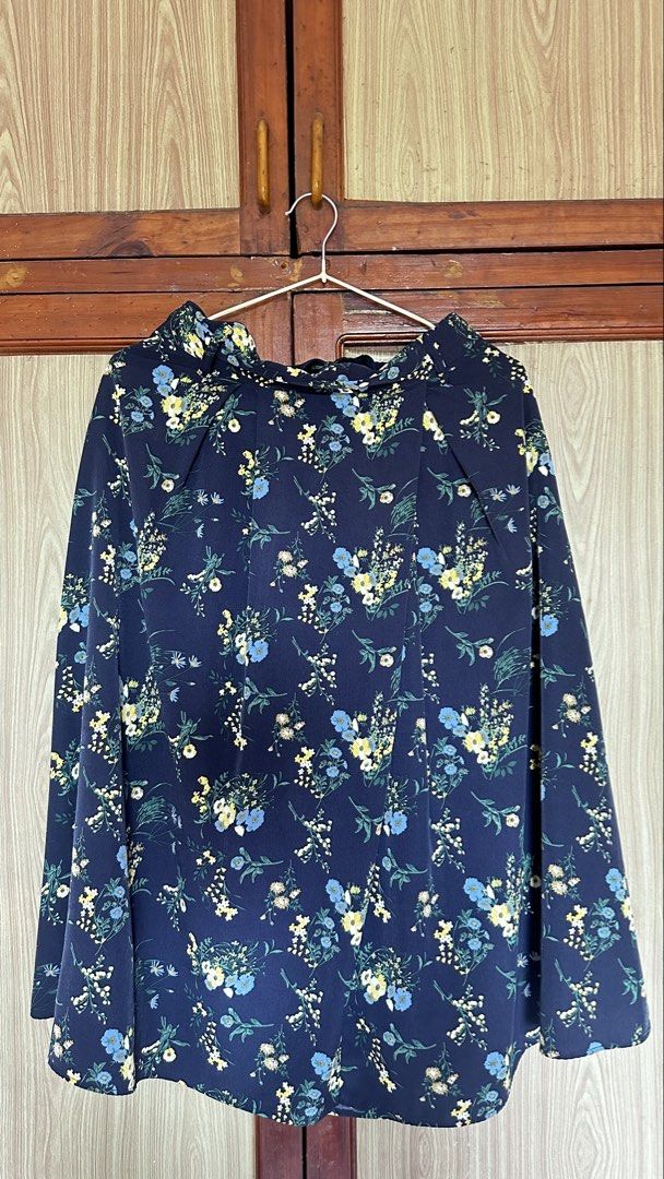 Navy Blue Floral Skirt (Category: Skirts) located in Quezon City. Submitted by cat_0820 (Listing ID 1456287082, Image 1). Description: - Navy blue blouse with a charming all-over floral print. - Features blue and yellow flowers with green leaves. - Elegant ruffled neckline. - Long sleeves. - Perfect for both casual and dressy outfits..