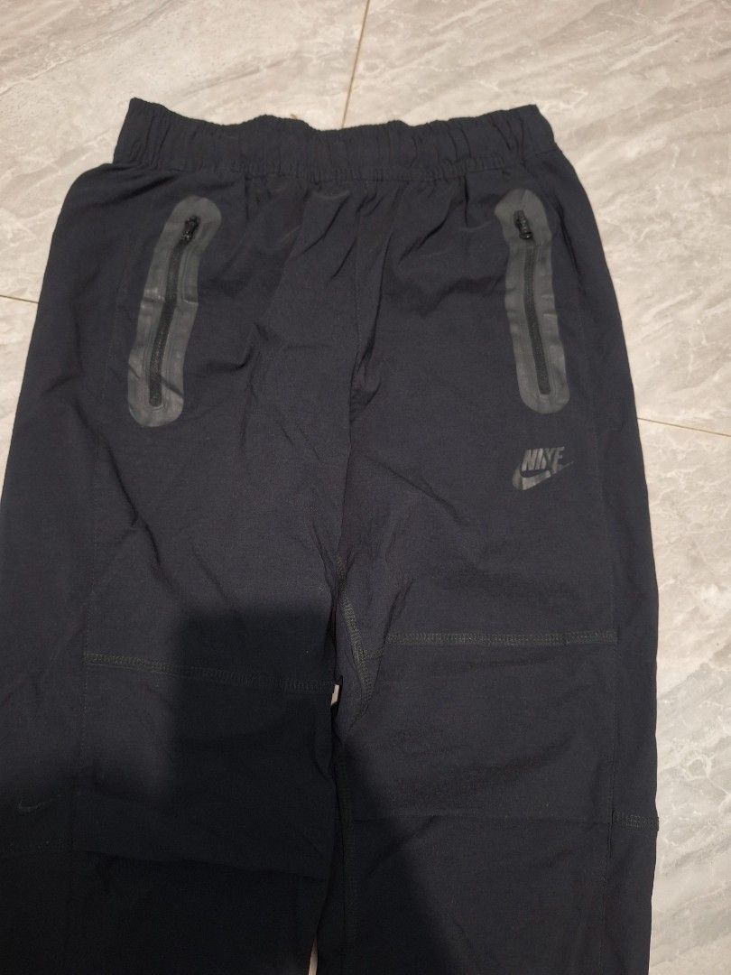Nike tech woven trousers WMNS (Category: Other Bottoms) located in Palayan City. Submitted by erae_lf (Listing ID 1456403633, Image 3). Description: Nike tech woven trousers WMNS Garterized Waistband with drawstring Woven fabric / Quick dry 3 pockets Like new ❗Issue minimal cut yung logo Check last photo for referrence Condition: 9/10 Color rate: 9/10 Size Medium on tag Waist: 26-30" best fit Length: 34.5" Thigh: 10.5" Opening: 6" with zipper ope