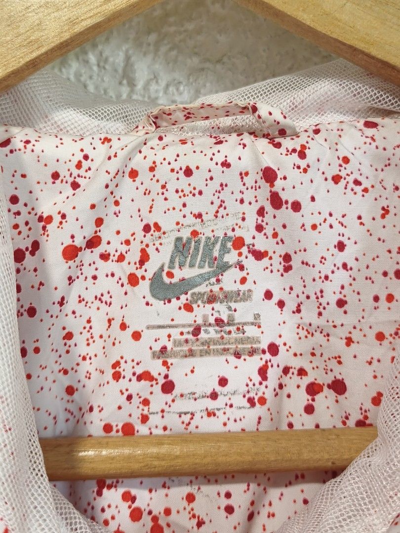 Nike Windbreaker Jacket Red Splatter Print (Category: Coats, Jackets and Outerwear) located in Iloilo. Submitted by daddy_declutter (Listing ID 1456285150, Image 3). Description: Dimes: L 25 x W 20 Cool Nike windbreaker jacket, red and white with splatter paint. Features a hood, zip-up front, and side pockets. Unique Nike shoe charm zipper pull. Perfect for casual style..